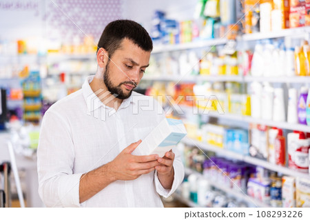 Bearded man choosing cosmetic product at pharmacy 108293226