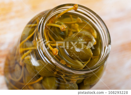Glass jar with pickled green capers Glass jar with pickled green capers 108293228