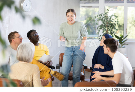 Woman tells an interesting story. Multinational students listening carefully in classroom Woman tells an interesting story. Multinational students listening carefully in classroom 108293229