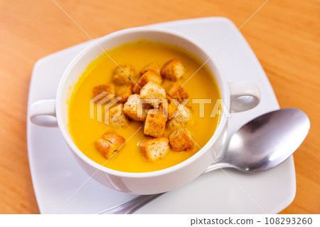 In plate, delicate cream soup is mashed from seasonal vegetables with addition of small crackers 108293260