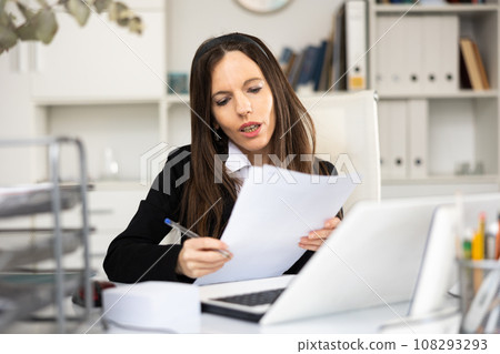 Portrait of woman office worker doing paperwork 108293293