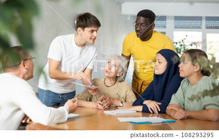 Group of multinational people making notes at table 108293295