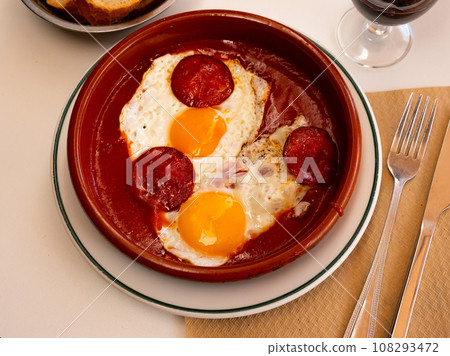 Spanish tapas with chorizo sausage and tomato paste closeup 108293472