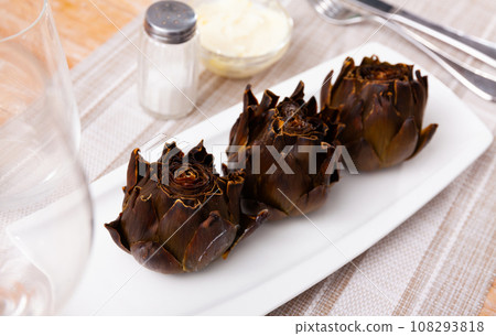 Top view of vegetarian appetizer of chargrilled artichokes served on plate 108293818