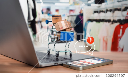 Shopping carts and product boxes Place on laptop computer showing online shopping concept, website, e-commerce, market platform, technology and online payment concept. Shopping carts and product boxes Place on laptop computer showing online shopping concept, website, e-commerce, market platform, technology and online payment concept. 108294507