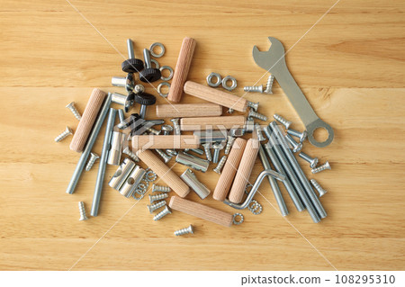 Assembly furniture tool kit with screw dowel wrench and bolt on wood table 108295310