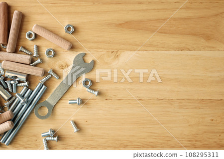 Assembly furniture tool kit with screw dowel wrench and bolt on wood table 108295311