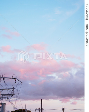 pink clouds floating in the sunset sky 108295367