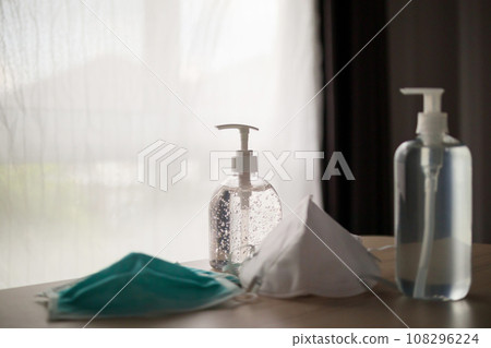 Medical face mask with alcohol sanitizer gel hand wash on wood table for covid-19 Coronavirus prevention concept Medical face mask with alcohol sanitizer gel hand wash on wood table for covid-19 Coronavirus prevention concept 108296224