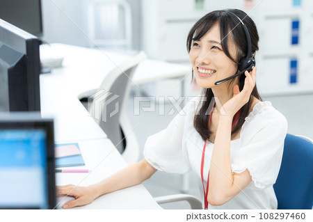 Young business woman working in a call center 108297460
