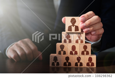 An image of choosing a leader and creating a team. team building. A man stacking wooden blocks. person icon and 108298362