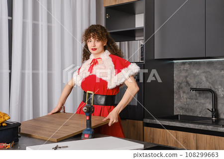 The snowgirl screwed the door hinges to the kitchen cabinet door and lifted it The snowgirl screwed the door hinges to the kitchen cabinet door and lifted it 108299663
