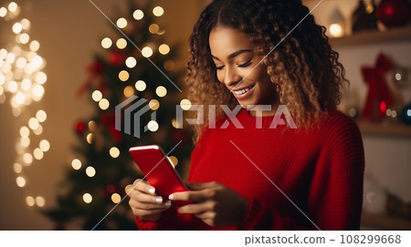 Young woman in a red sweater orders gifts during Young woman in a red sweater orders gifts during 108299668