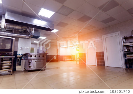 Industrial kitchen in a school restaurant with professional equipment and pans 108301740