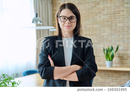 Portrait of business confident woman with crossed arms in office 108301995
