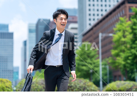 A middle-aged businessman in a managerial position working in an office district A middle-aged businessman in a managerial position working in an office district 108303451