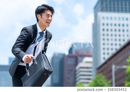 A middle-aged businessman in a managerial position working in an office district A middle-aged businessman in a managerial position working in an office district 108303452