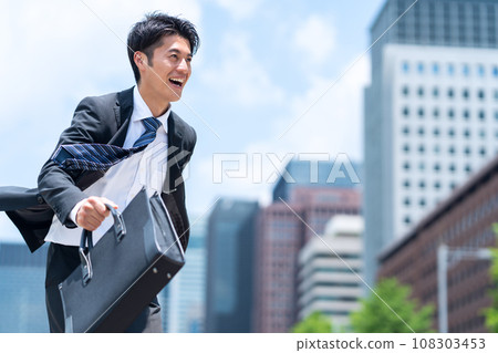 A middle-aged businessman in a managerial position working in an office district A middle-aged businessman in a managerial position working in an office district 108303453