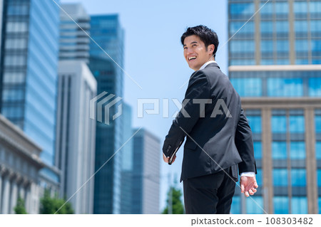 A middle-aged businessman in a managerial position working in an office district A middle-aged businessman in a managerial position working in an office district 108303482