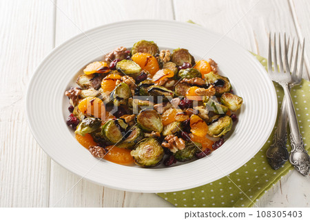 Homemade Cranberry Brussel Sprouts Mandarin salad with Balsamic Dressing close-up in a plate. Horizontal 108305403