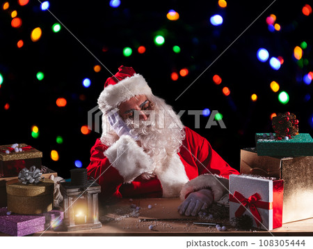 Tired santa claus is sleeping due to christmas overwork 108305444