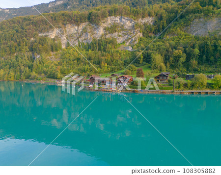 Aerial top view of garden park with green mangrove forest trees, river, pond or lake. Nature landscape background, iseltwald, Switzerland. Aerial top view of garden park with green mangrove forest trees, river, pond or lake. Nature landscape background, iseltwald, Switzerland. 108305882
