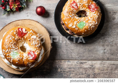 Individual Epiphany cake roscon de reyes on wooden table Individual Epiphany cake roscon de reyes on wooden table 108306587