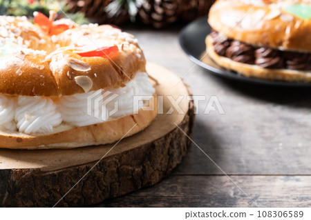 Individual Epiphany cake roscon de reyes on wooden table Individual Epiphany cake roscon de reyes on wooden table 108306589