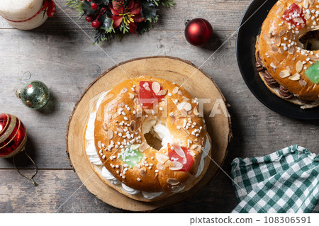 Individual Epiphany cake roscon de reyes on wooden table Individual Epiphany cake roscon de reyes on wooden table 108306591