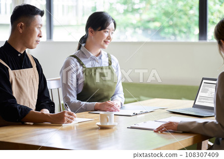 Restaurant manager listening to businesswoman's presentation Restaurant manager listening to businesswoman's presentation 108307409