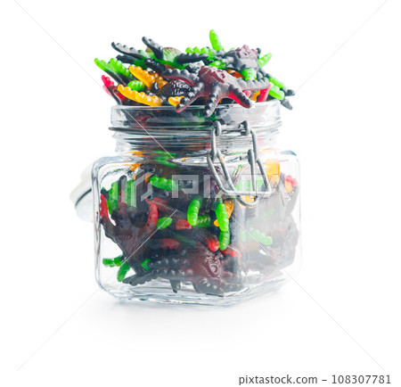 Scary sweet jelly spiders. Halloween candies in jar isolated on white background. 108307781