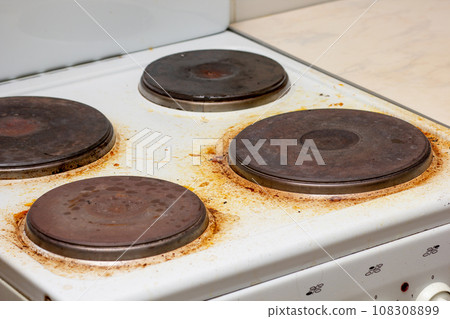 Dirty electric stove with fat on surface 108308899