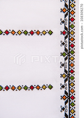 Element of Handmade Embroidery on White Linen by colored Cotton Threads. Design of ethnic pattern. 108309270