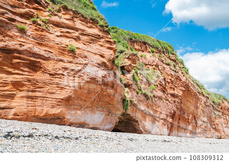 Rock formations in Ladram Bay, United Kingdom. View of the beach and red and orange cliffs and the sea, Jurassic coast, selective focus Rock formations in Ladram Bay, United Kingdom. View of the beach and red and orange cliffs and the sea, Jurassic coast, selective focus 108309312