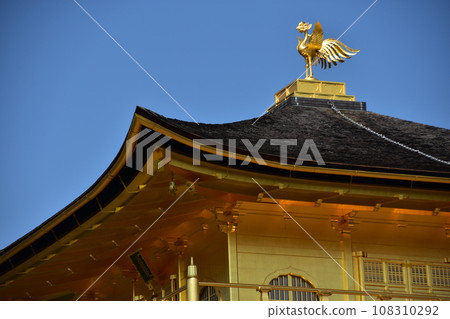 Close-up photo of Shariden, Kinkakuji Temple, a world heritage site in Kyoto, Japan. Golden phoenix decorated on the roof 108310292