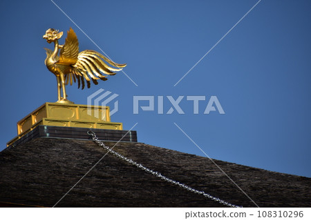 Close-up photo of Shariden, Kinkakuji Temple, a world heritage site in Kyoto, Japan. Golden phoenix decorated on the roof Close-up photo of Shariden, Kinkakuji Temple, a world heritage site in Kyoto, Japan. Golden phoenix decorated on the roof 108310296