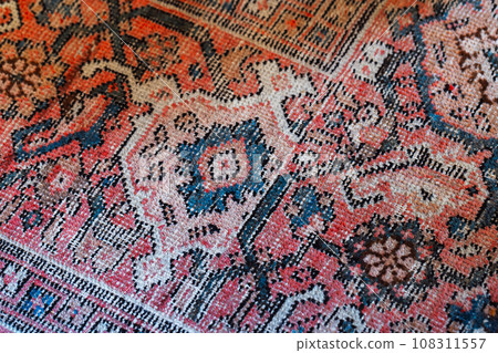 Old oriental woolen carpet with traditional colorful floral ornament Old oriental woolen carpet with traditional colorful floral ornament 108311557