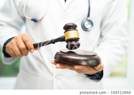 Doctor holding judge gavel, forensic medicine, medical law and crime justice concept. 108312660