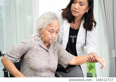 Caregiver help Asian senior woman on wheelchair and wearing a face mask for protect safety infection Covid19 Coronavirus. 108312727