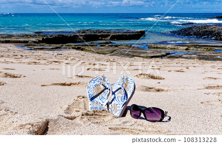 Flip flops and sunglass on Playa de los Ojos - Fuerteventura, Canary Islands, Spain Flip flops and sunglass on Playa de los Ojos - Fuerteventura, Canary Islands, Spain 108313228