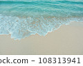 Soft wave of blue ocean on sandy beach. Summer vacation in island. clear azure water Background. 108313941