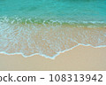 Soft wave of blue ocean on sandy beach. Summer vacation in island. clear azure water Background. 108313942
