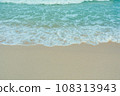 Soft wave of blue ocean on sandy beach. Summer vacation in island. clear azure water Background. 108313943