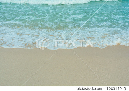 Soft wave of blue ocean on sandy beach. Summer vacation in island. clear azure water Background. Soft wave of blue ocean on sandy beach. Summer vacation in island. clear azure water Background. 108313943