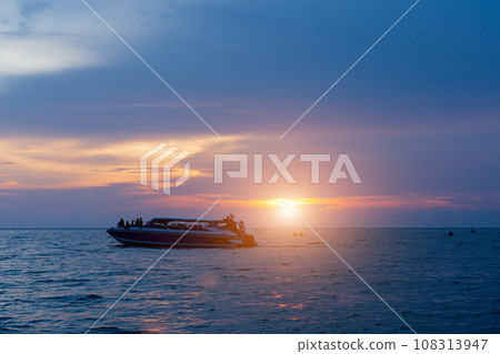speed boat on the sea with sunset sky background. speed boat on the sea with sunset sky background. 108313947