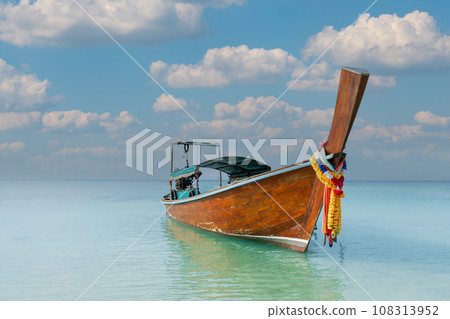 Thai traditional wooden longtail boat and beautiful sand Railay Beach in Krabi province, Thailand. 108313952