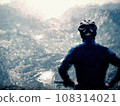 Teenager boy sit on mountain bike and watching from Alps peak down. Dolomite Alps, Teenager boy sit on mountain bike and watching from Alps peak down. Dolomite Alps, 108314021