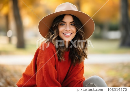 Young Hispanic woman in hat and sweater, street portrait. Fall season lifestyle concept 108314370