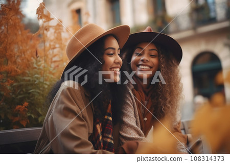Interracial friends or lesbian couple in city on fall Europe vacation. Lifestyle and travel concept 108314373