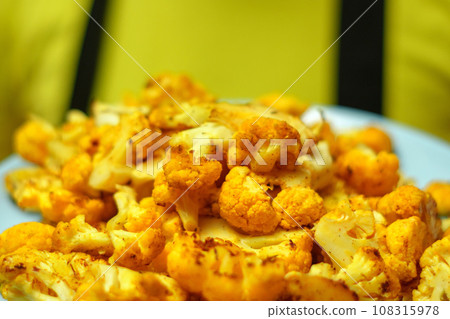 Steak of baked cauliflower with herbs. Healthy eating. Selective focus Steak of baked cauliflower with herbs. Healthy eating. Selective focus 108315978